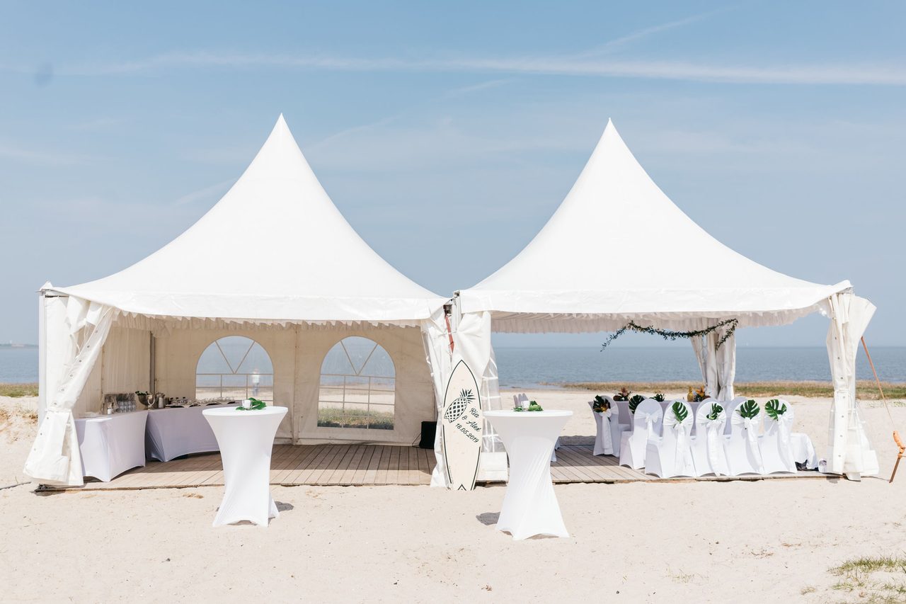 Weiße Pagodenzelte mit Catering am Strand